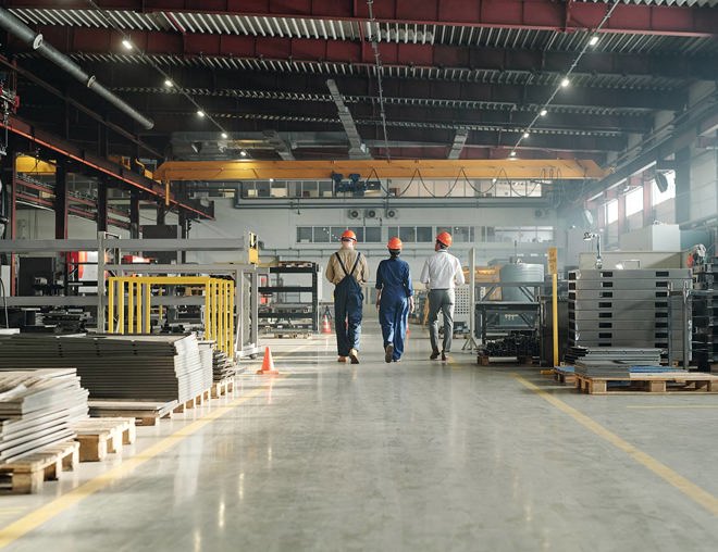 3 workers walking through an industrial building