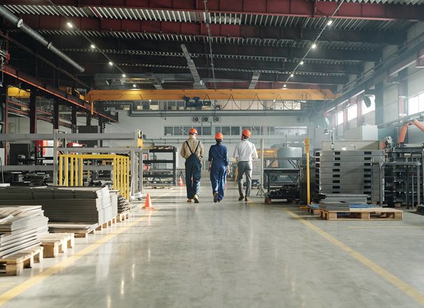 3 workers walking through an industrial building