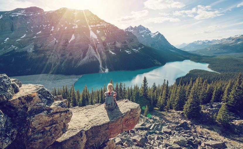 Hiker resting while looking over a mountain lake