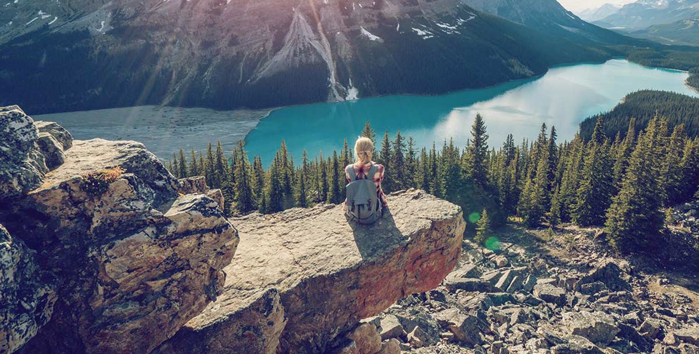 Hiker resting while looking over a mountain lake