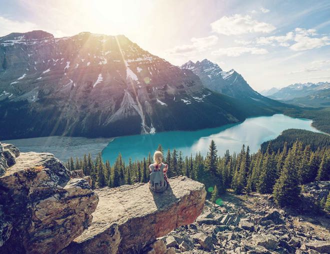 Hiker resting while looking over a mountain lake