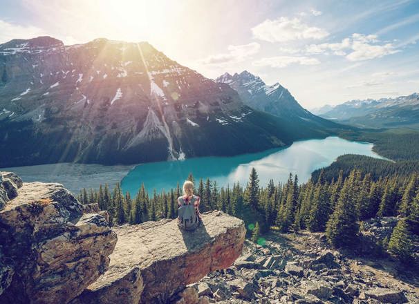 Hiker resting while looking over a mountain lake