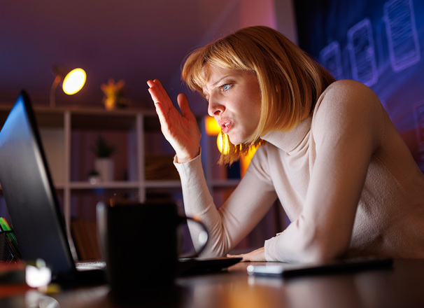 Someone anxious working on laptop at night
