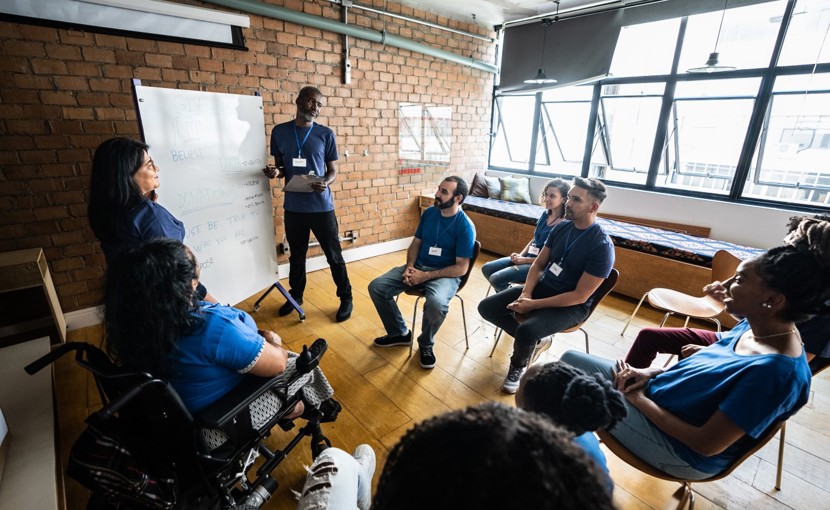 Person teaching a group of mature students.