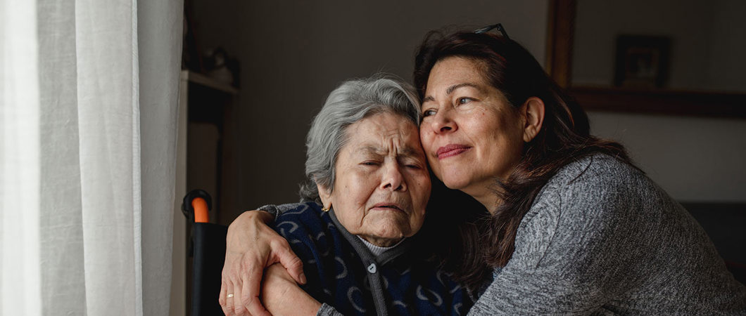 2 people hugging while at home