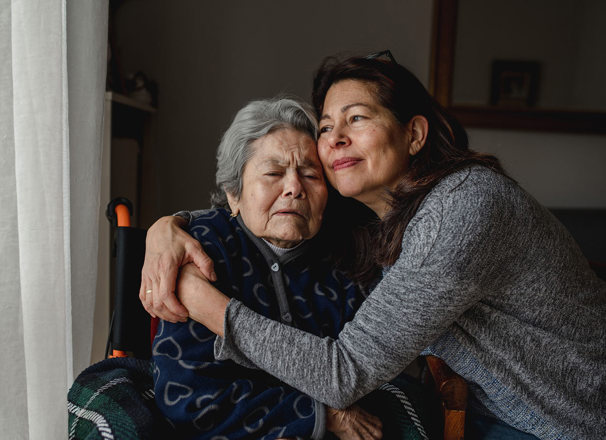 2 people hugging while at home