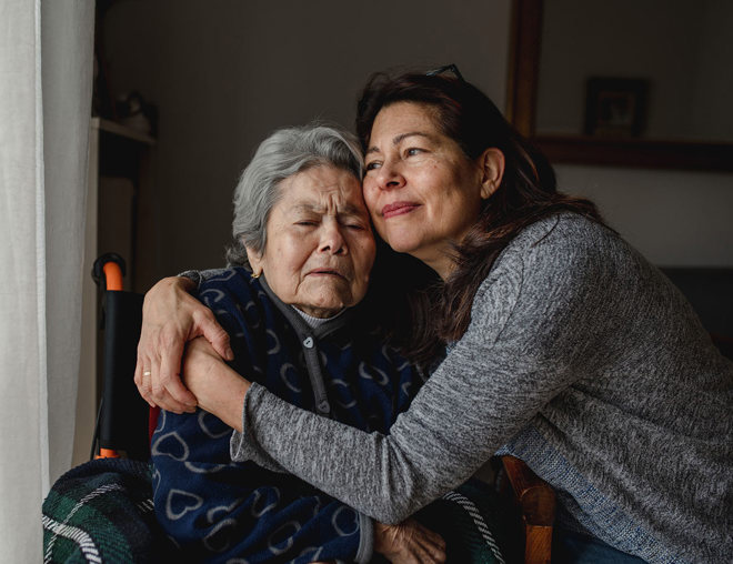 2 people hugging while at home