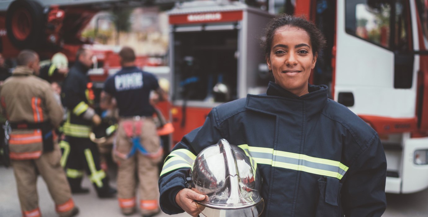 firefighter standing in a firehall