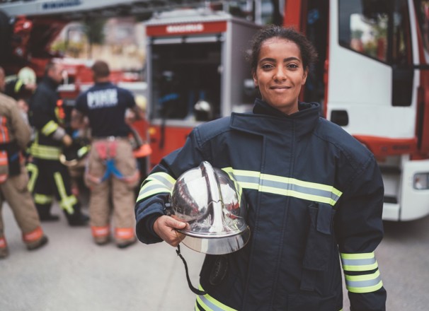 firefighter standing in a firehall