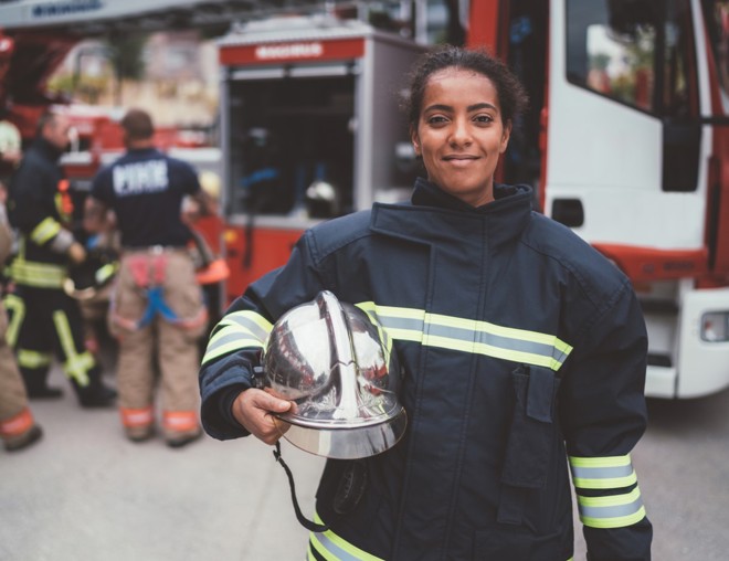 firefighter standing in a firehall
