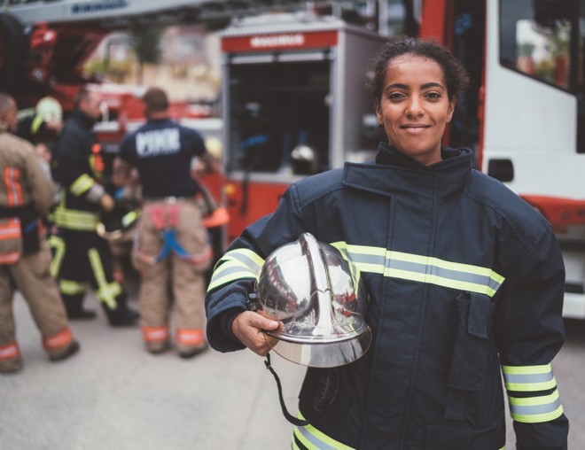 firefighter standing in a firehall