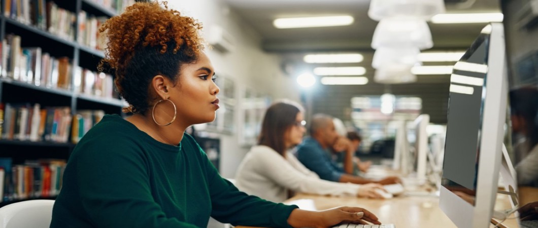 Job seeker using a desktop computer in a library.