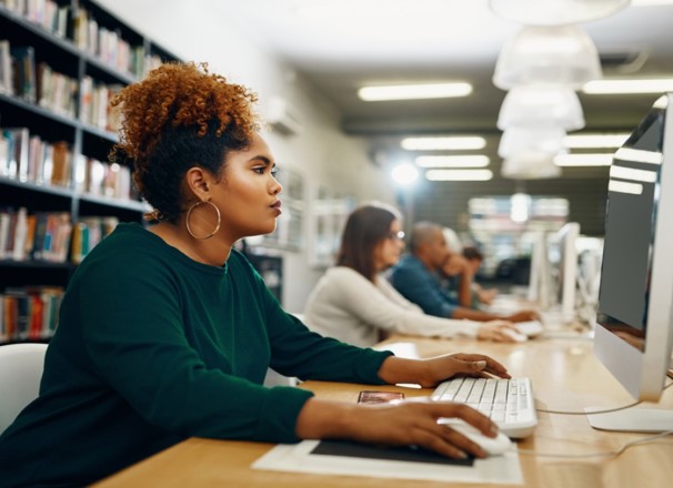 Job seeker using a desktop computer in a library.