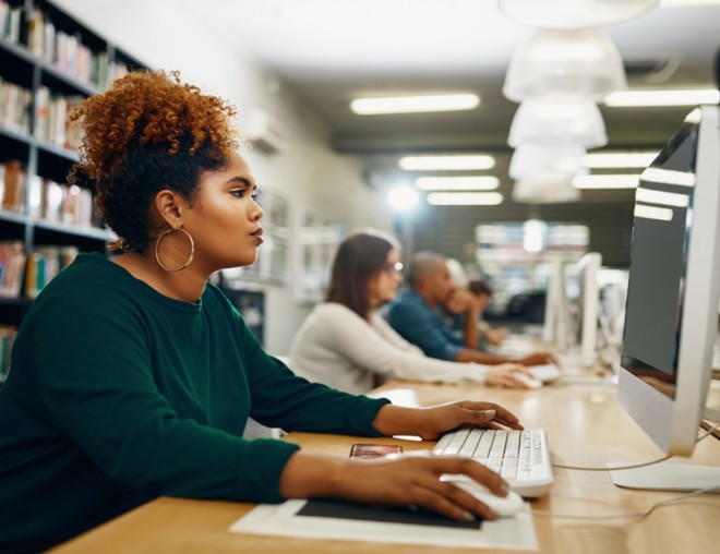 Job seeker using a desktop computer in a library.