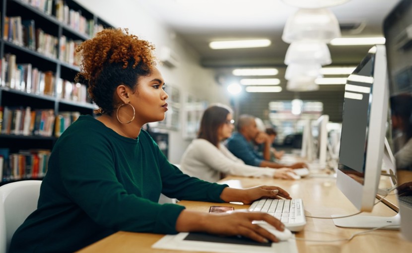Job seeker using a desktop computer in a library.