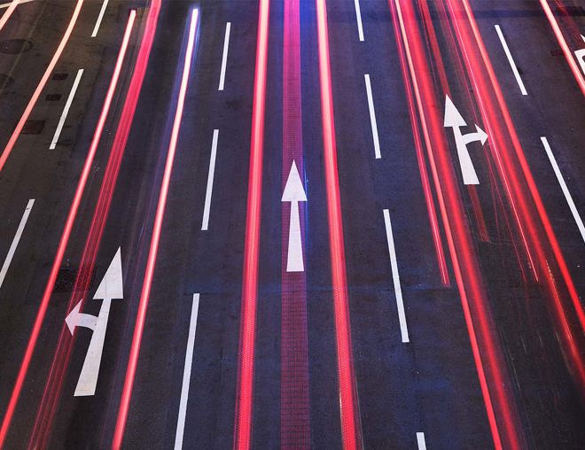 Arrows on a roadway at night
