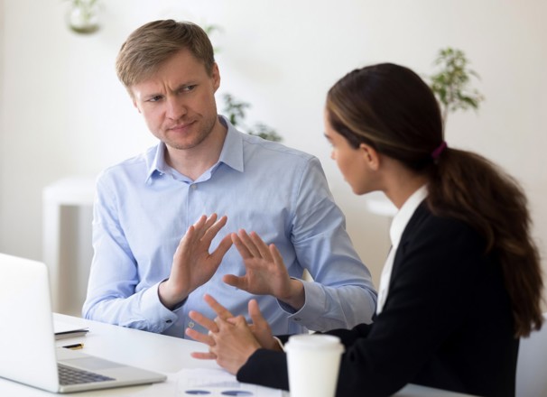 Co-workers having a disagreement in the office.