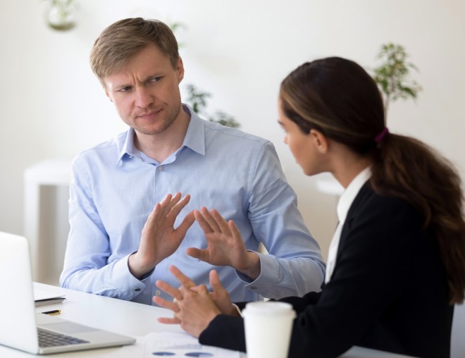 Co-workers having a disagreement in the office.