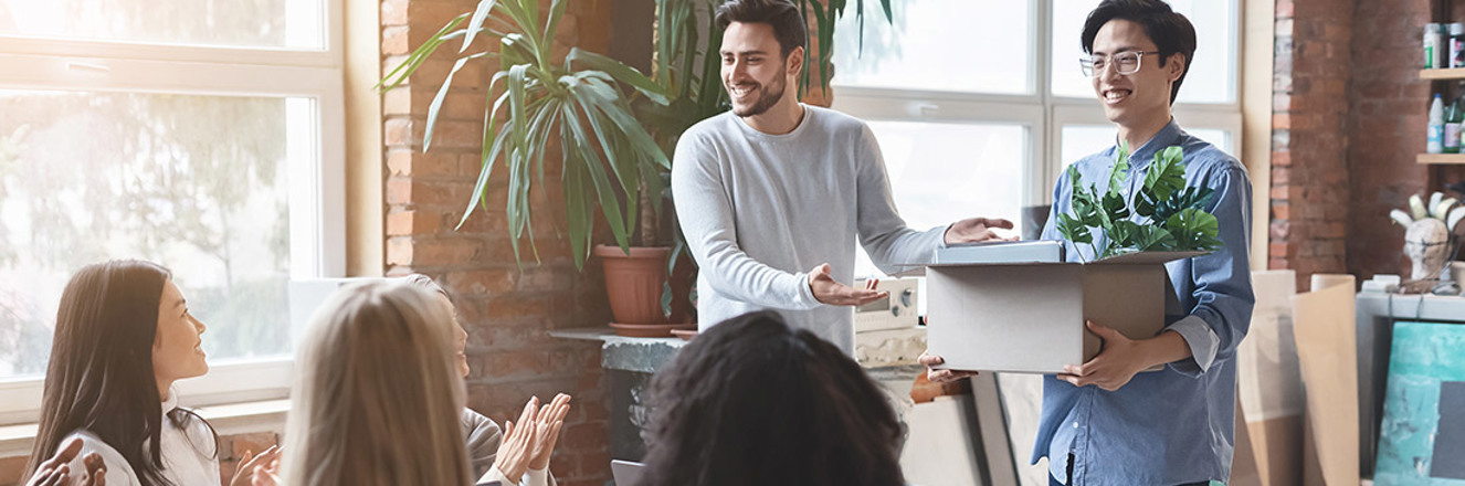 team cheering newcomer in office, manager introducing new employee