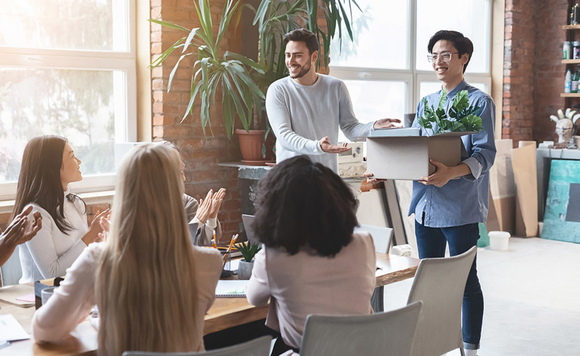 team cheering newcomer in office, manager introducing new employee