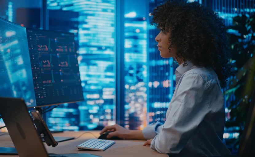 Dealing representative working on a computer at a desk