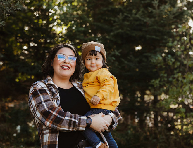 Indigenous mom holding child