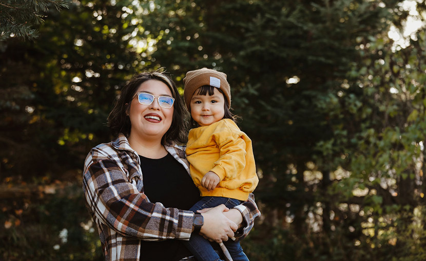 Indigenous mom holding child