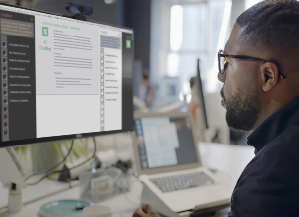 Person using desktop computer to access generative AI software.