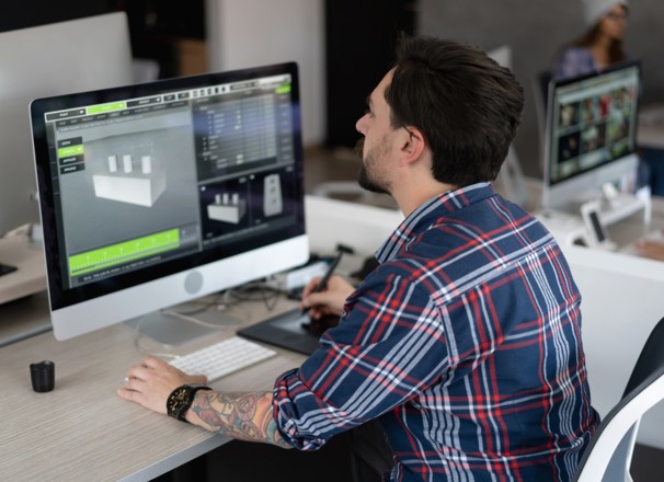Digital designer working on a 3D model on computer in office.
