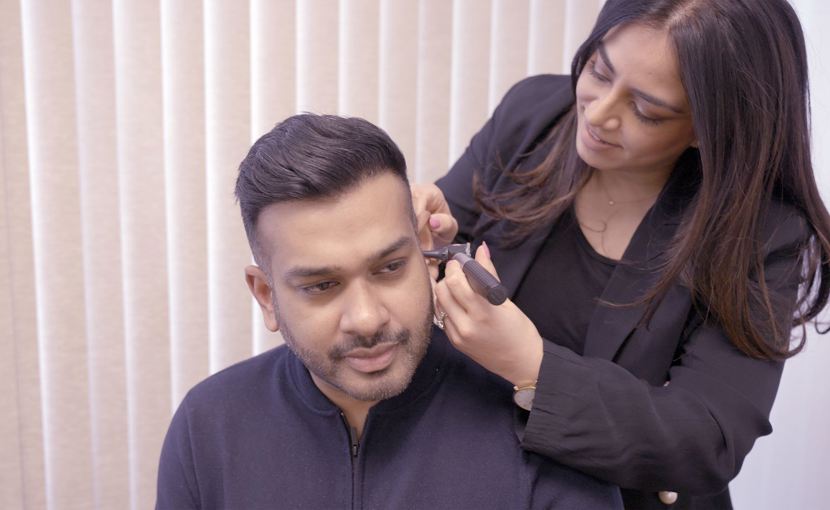 audiologist looking at ear with scope