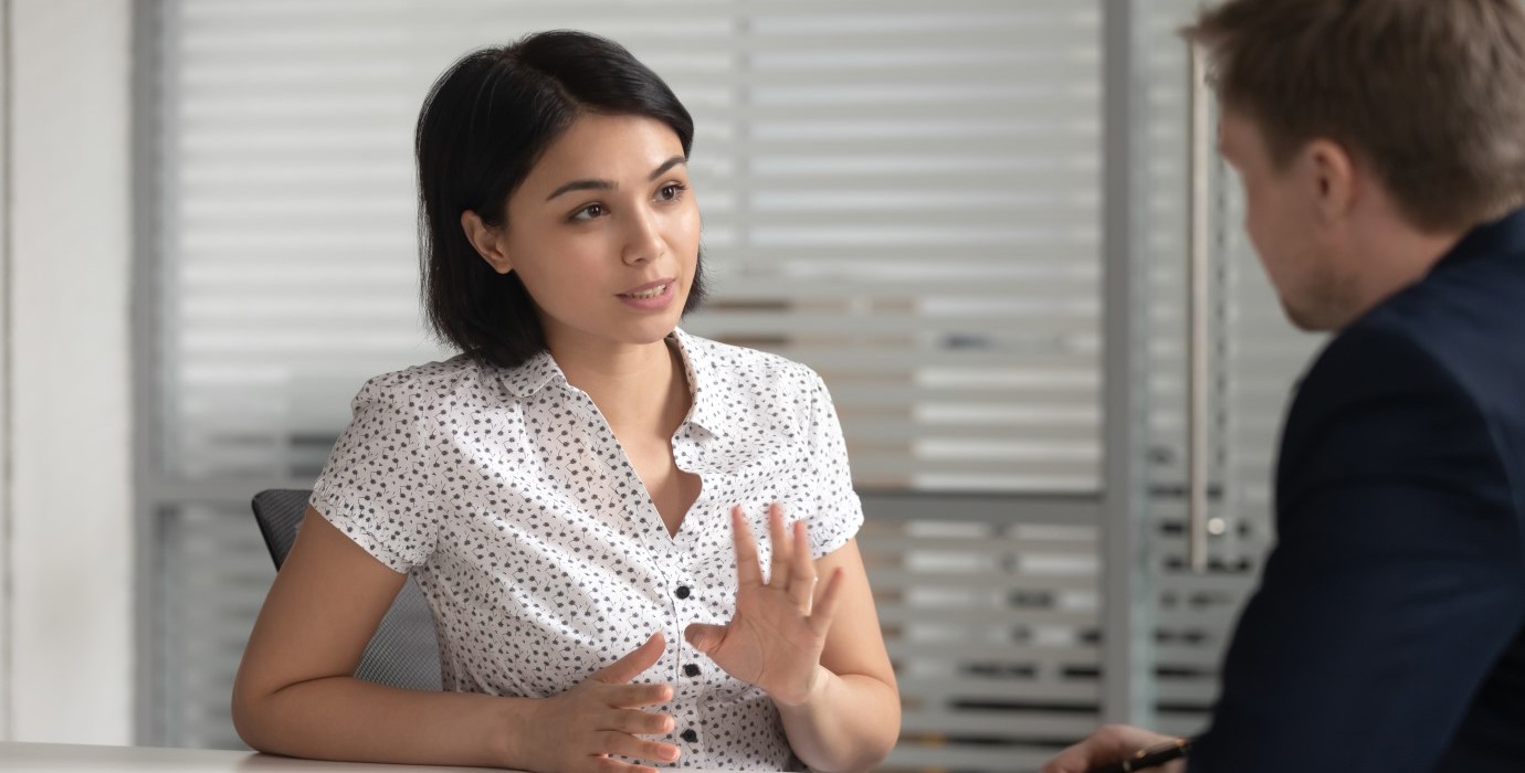 Female worker talking to her manager in office. 