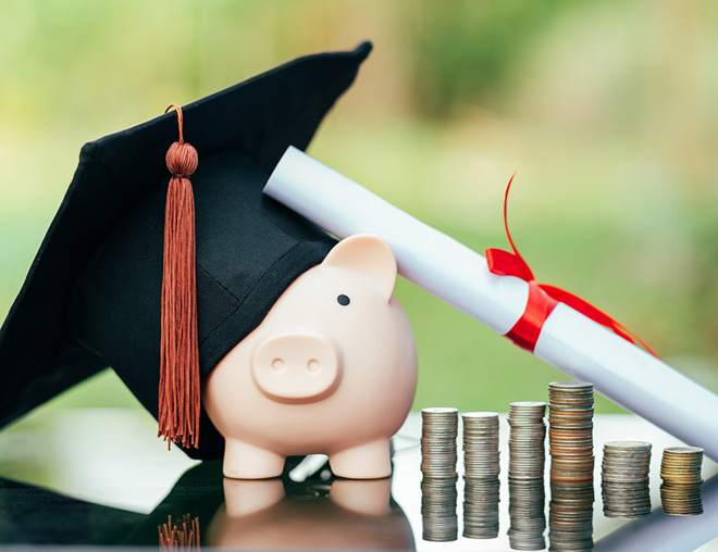 Scholarship concept with mortarboard, diploma, coins and piggy bank