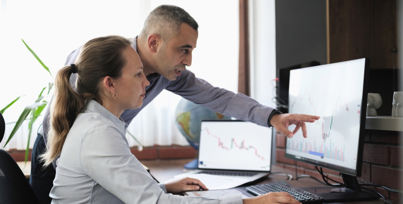 Business people working in the office, viewing data on a desktop computer.
