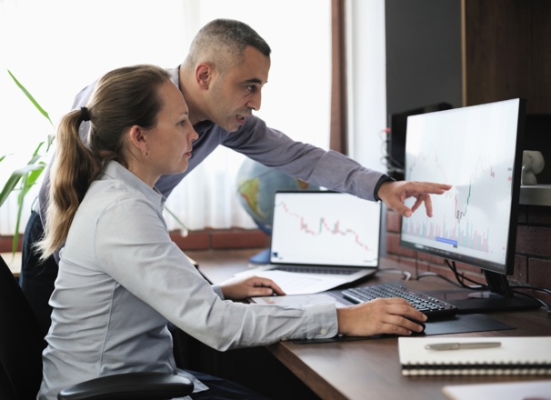 Business people working in the office, viewing data on a desktop computer.