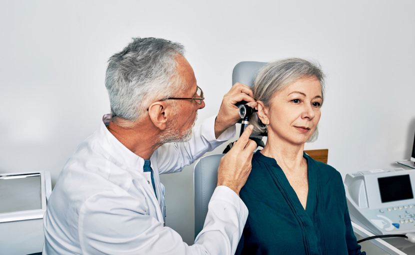 audiologist examining patient