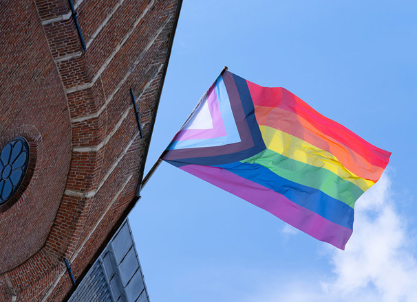 Pride flag flying on outside of building