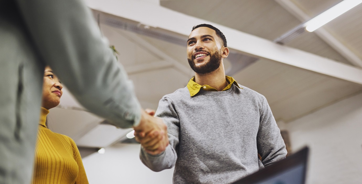 Two coworkers shaking hands.