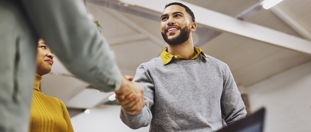 Two coworkers shaking hands.