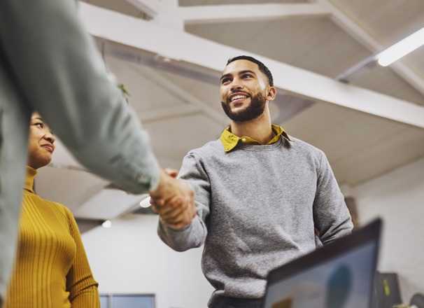 Two coworkers shaking hands.