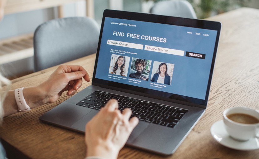 Person searching for free online courses on laptop.